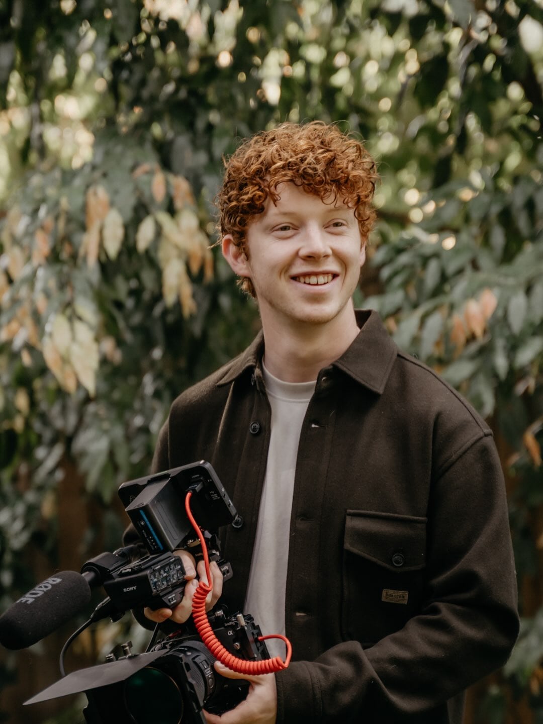 Benjamin holding his video camera outdoors